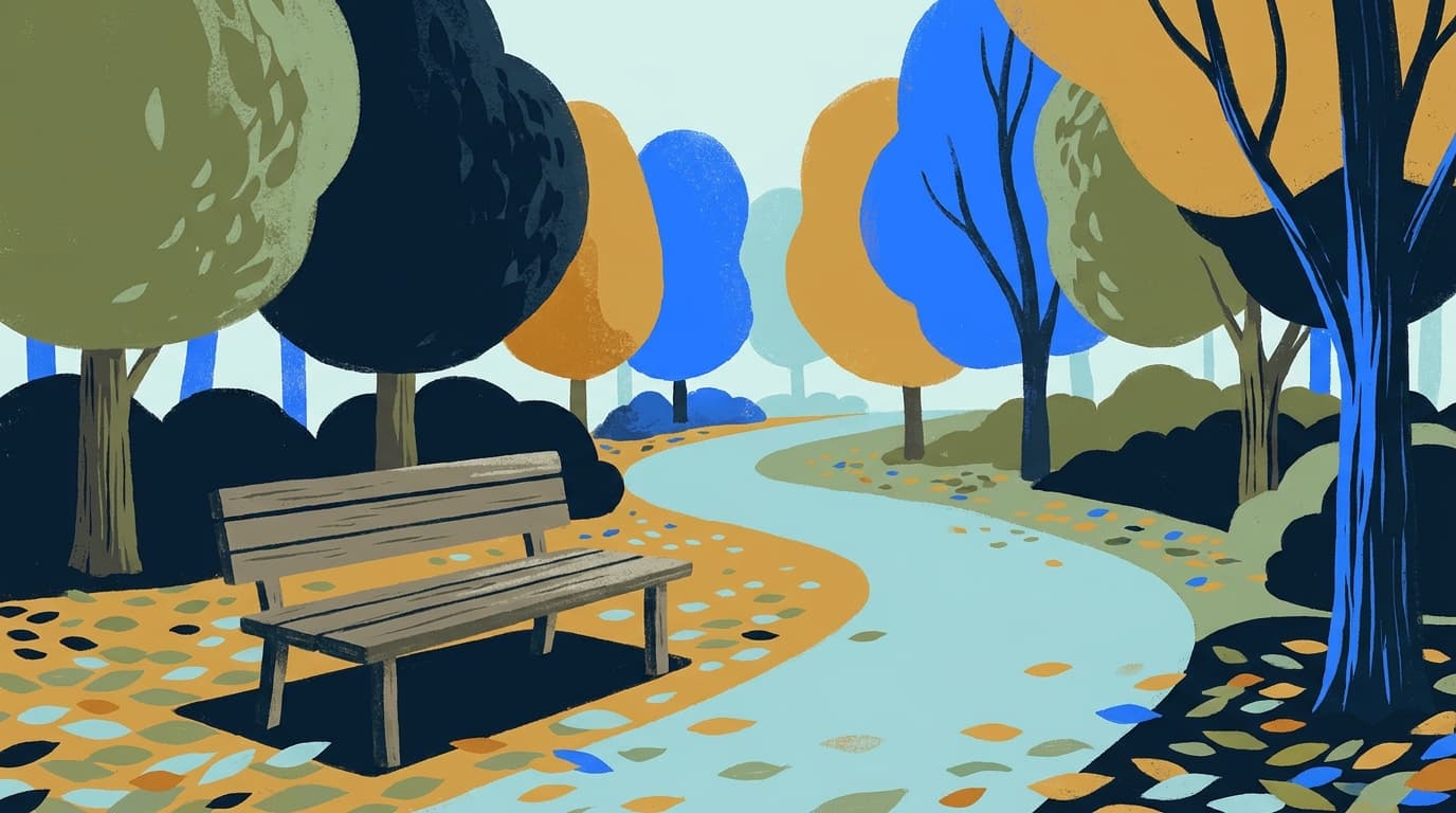 Un chemin de parc bordé d'arbres, avec un banc au premier plan